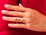 Gold rings with emerald-cut diamonds on a hand
