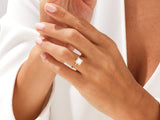 Gold princess cut diamond ring on a woman's hand