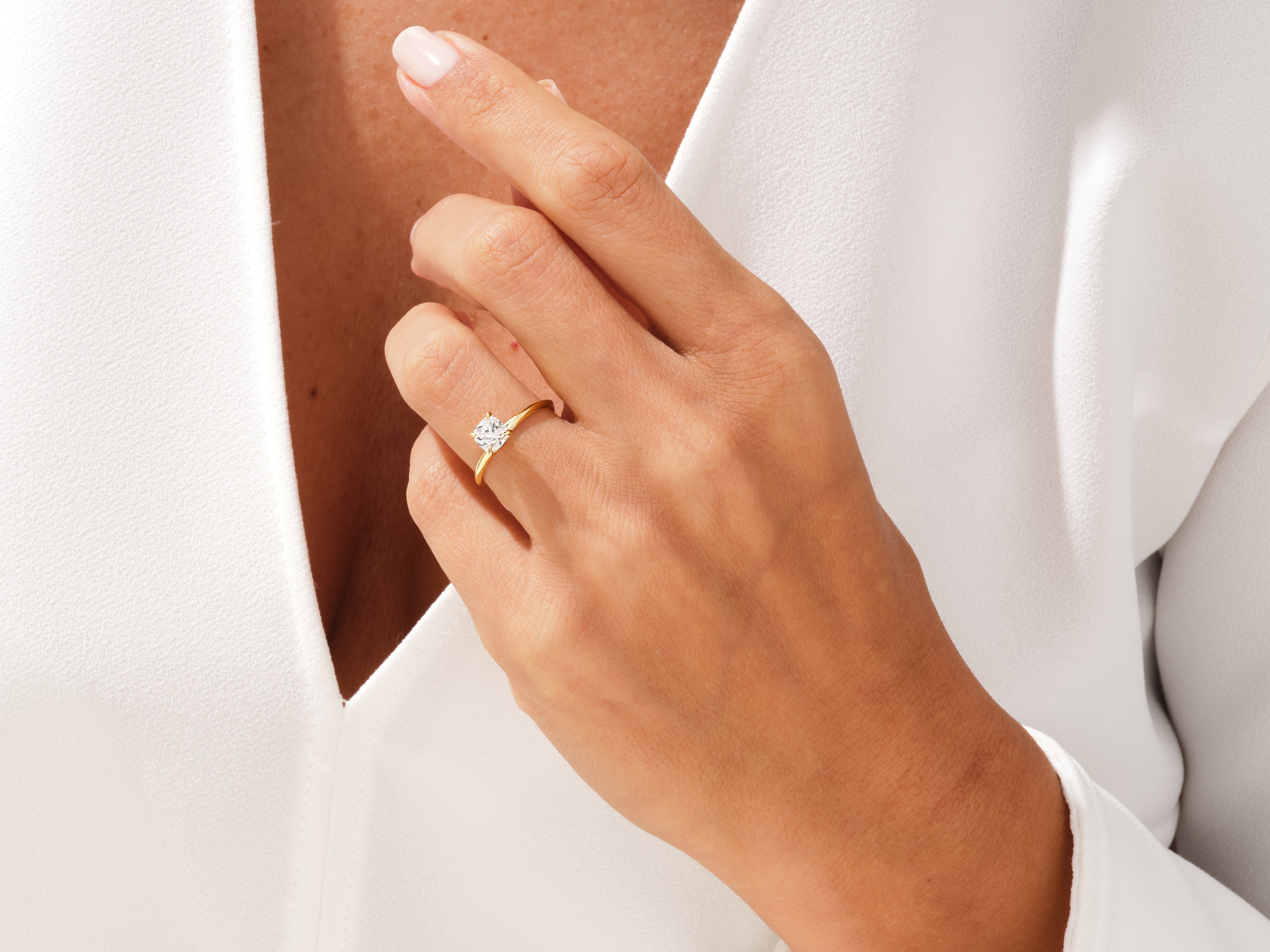 Gold diamond ring on a woman's hand, jewelry product shot