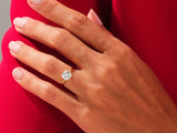 Gold ring with cushion-cut diamond on hand