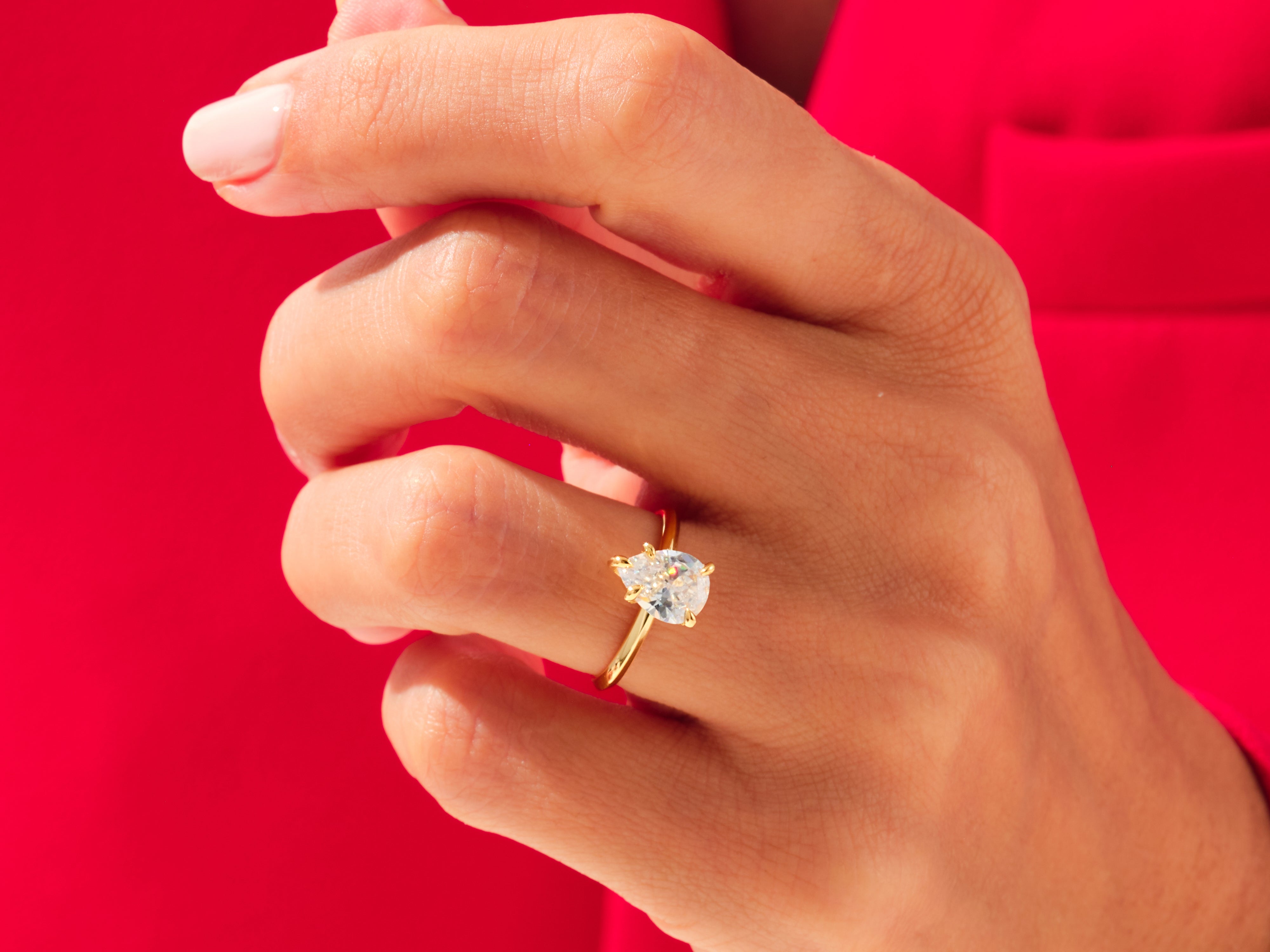 Pear cut diamond engagement ring on a hand, luxury jewelry