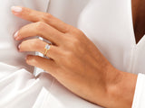 Gold ring with emerald-cut diamond on a woman's hand