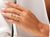 Gold rings with princess cut diamonds on a woman's hand