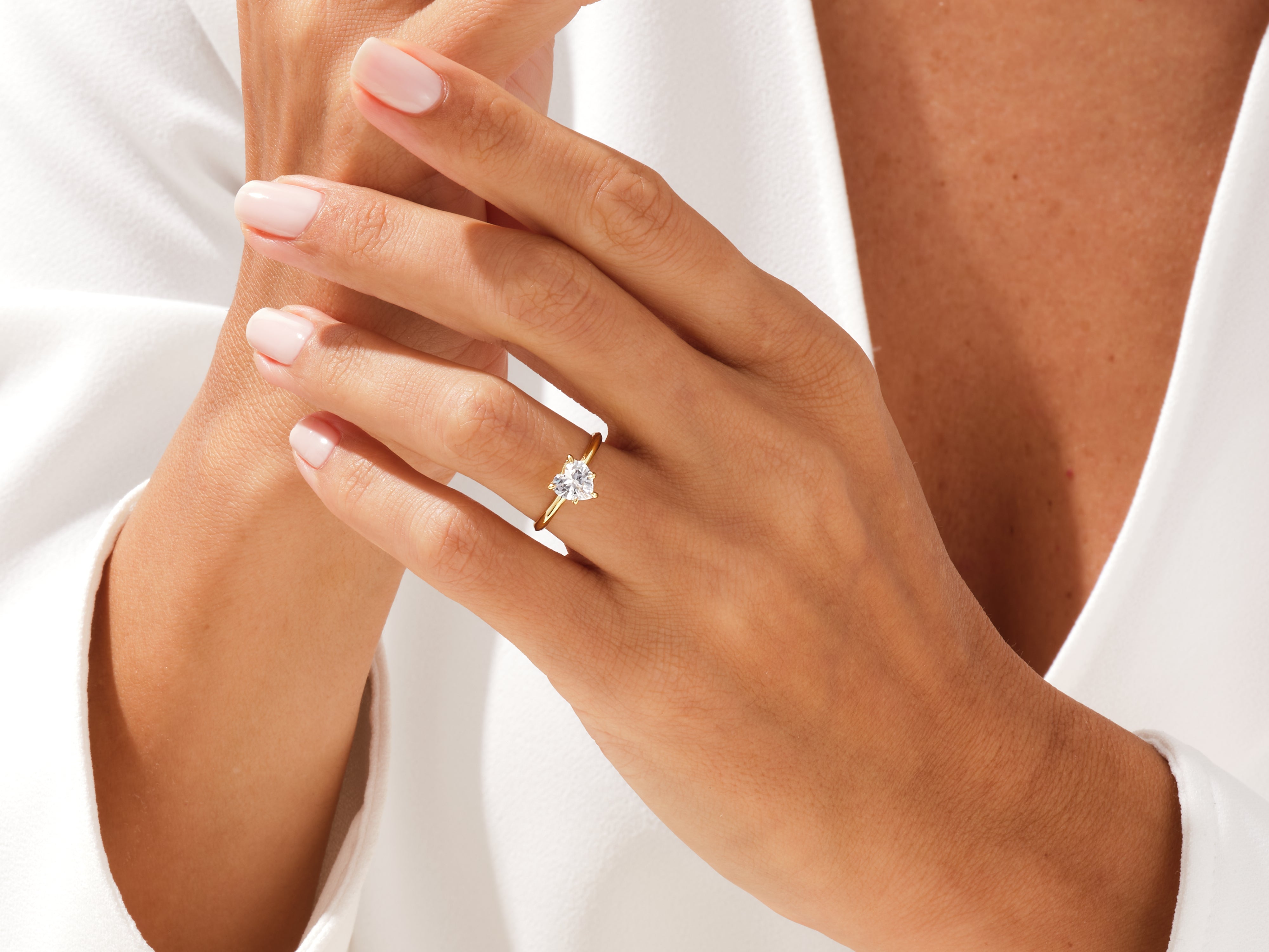 Gold heart diamond ring on a woman's hand