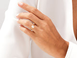 Gold ring with emerald cut diamond on hand
