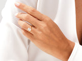 Gold ring with radiant cut diamond on a woman's finger
