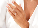 Gold ring with radiant cut diamond on a woman's hand