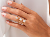 Gold rings with square diamonds on a woman's hand