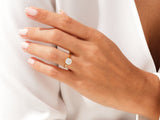 Gold ring with cushion-cut diamond on a woman's hand