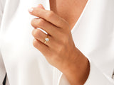 Gold ring with pear-shaped diamond on hand