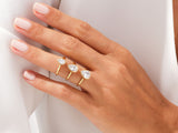 Gold rings with pear-shaped diamonds on a hand