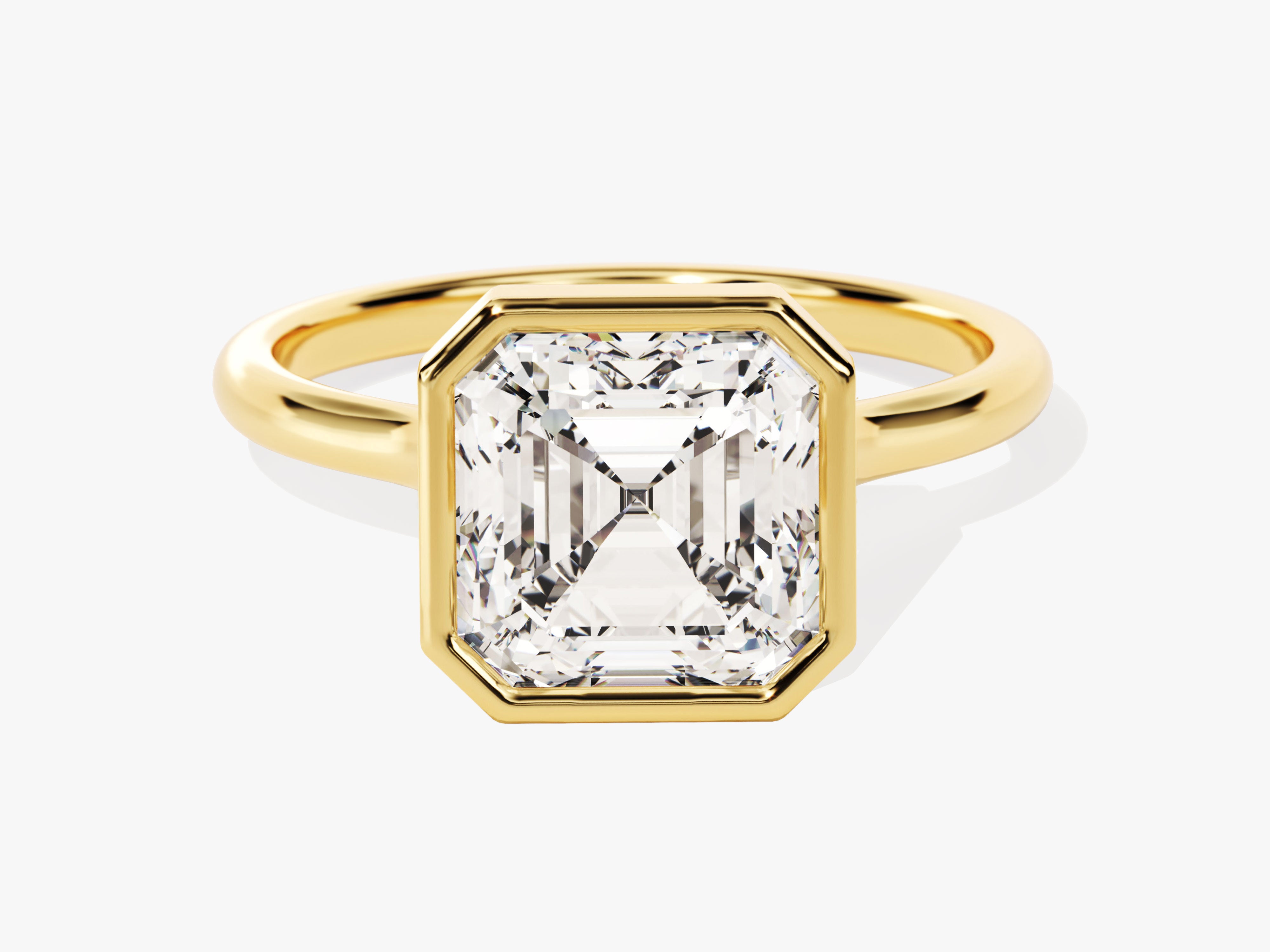 Gold ring with emerald-cut diamond bezel setting