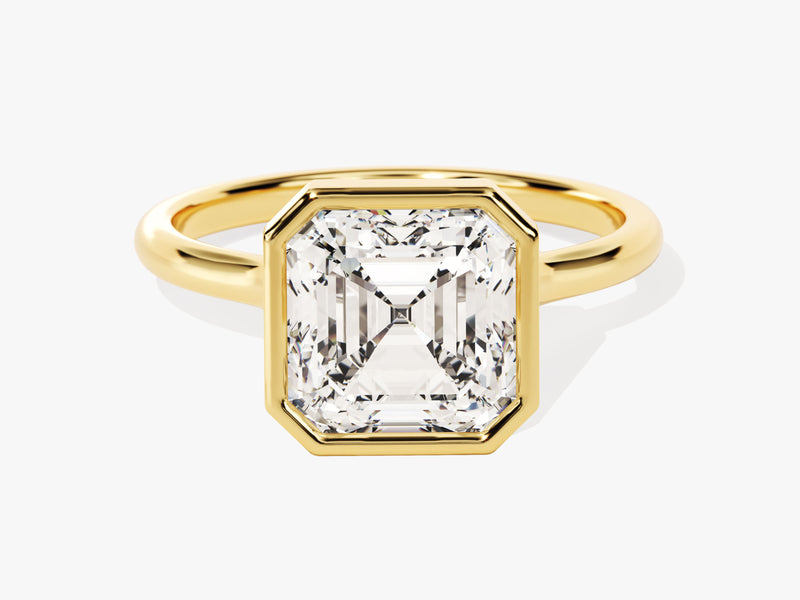 Gold ring with emerald-cut diamond bezel setting