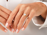 Gold heart diamond ring on a woman's finger