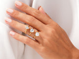 Gold heart rings with diamonds on a hand