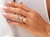 Gold rings with baguette diamonds on a hand
