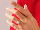 Gold ring with opal and diamond accents on a hand