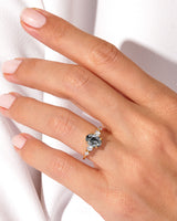 Gold ring with oval black tourmaline and diamonds on hand