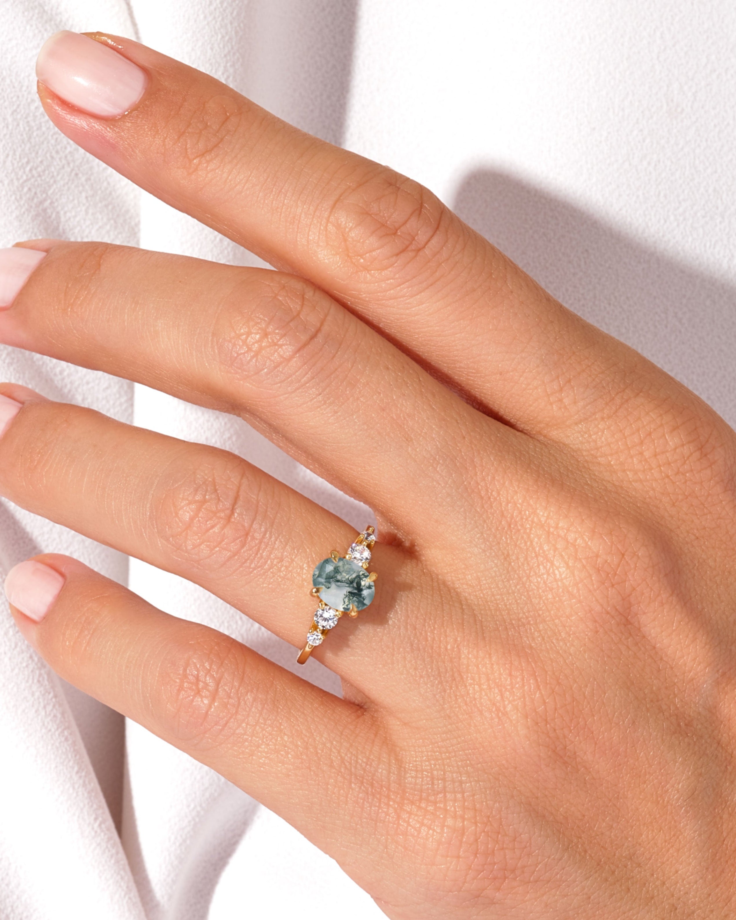 Gold ring with moss agate and diamonds on hand