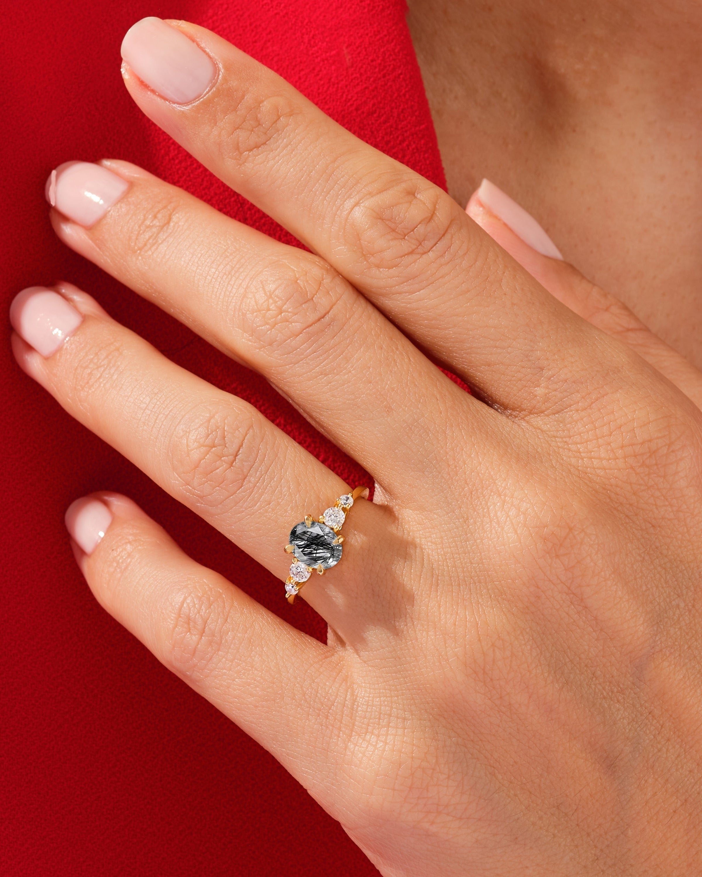 Gold ring with black tourmaline and diamonds on hand