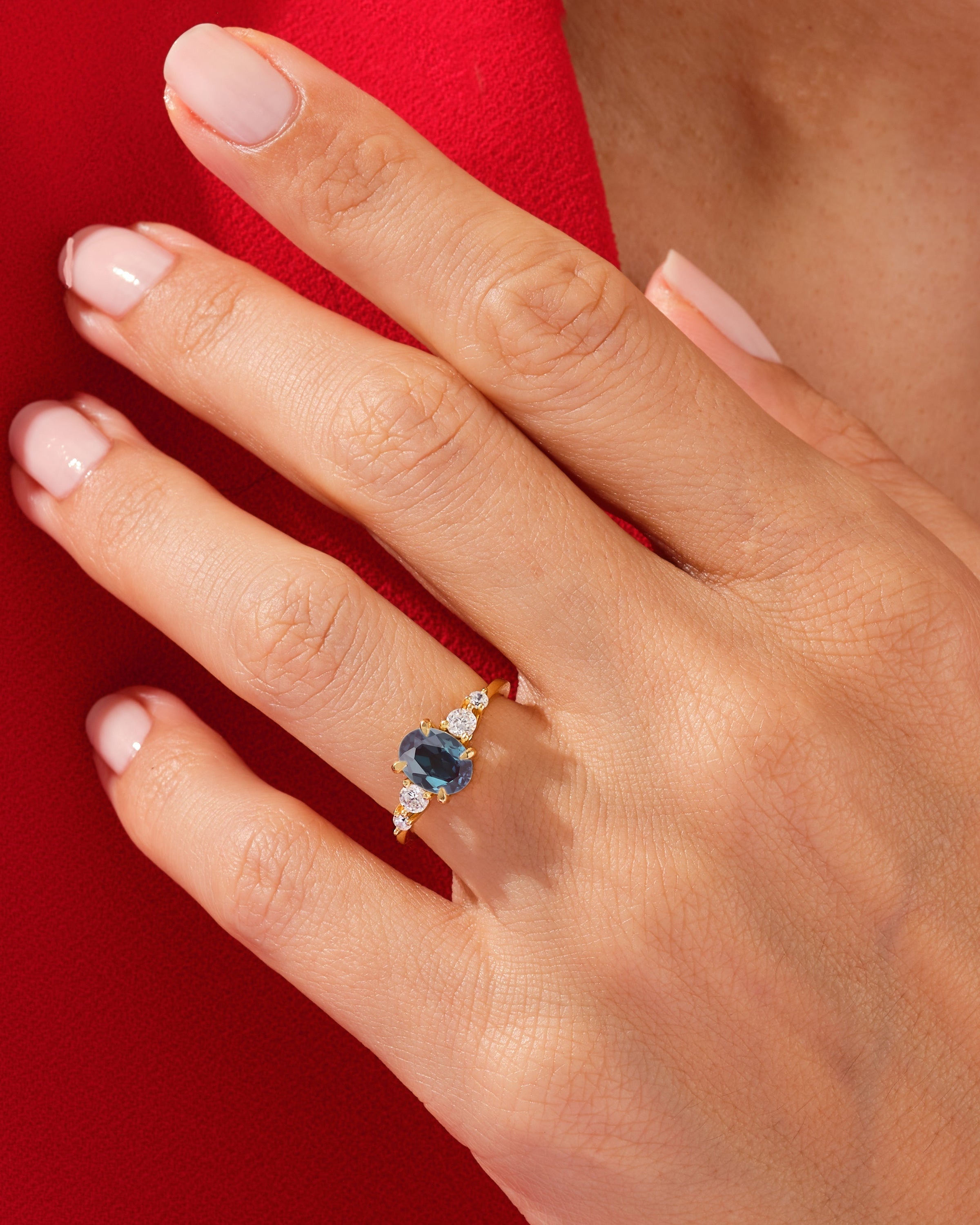 Oval sapphire and diamond ring on a hand
