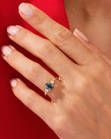 Oval sapphire and diamond ring on a hand