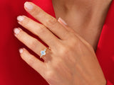 Gold ring with oval moonstone and diamonds on a hand