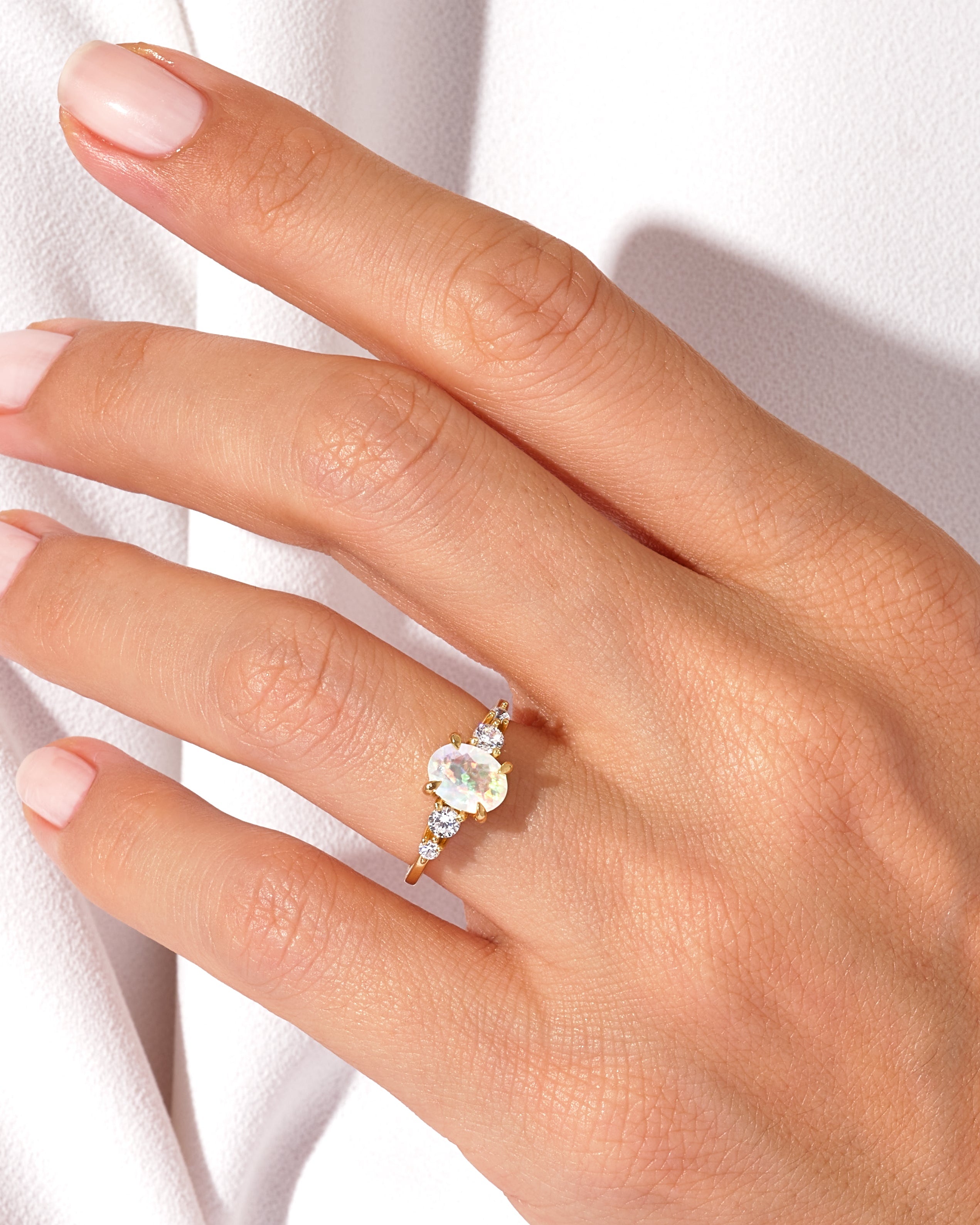 Gold opal and diamond ring on a woman's hand