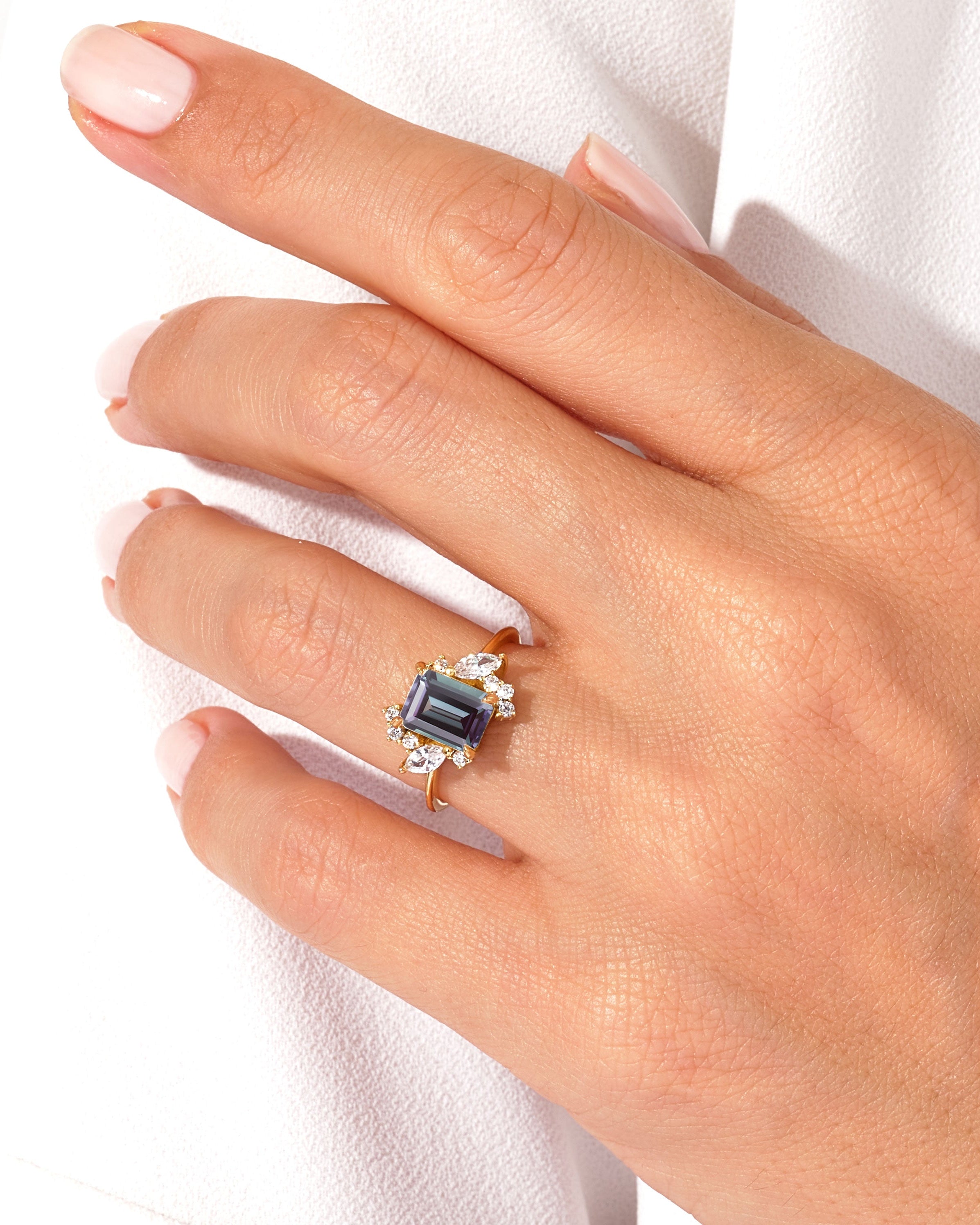 Emerald cut sapphire ring with diamonds on a gold band