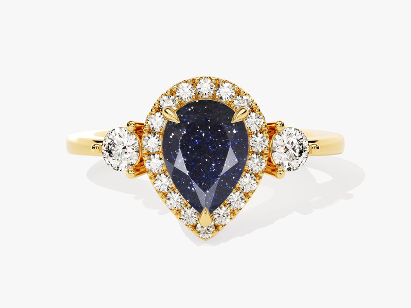 Gold ring with pear-shaped blue gemstone and diamonds