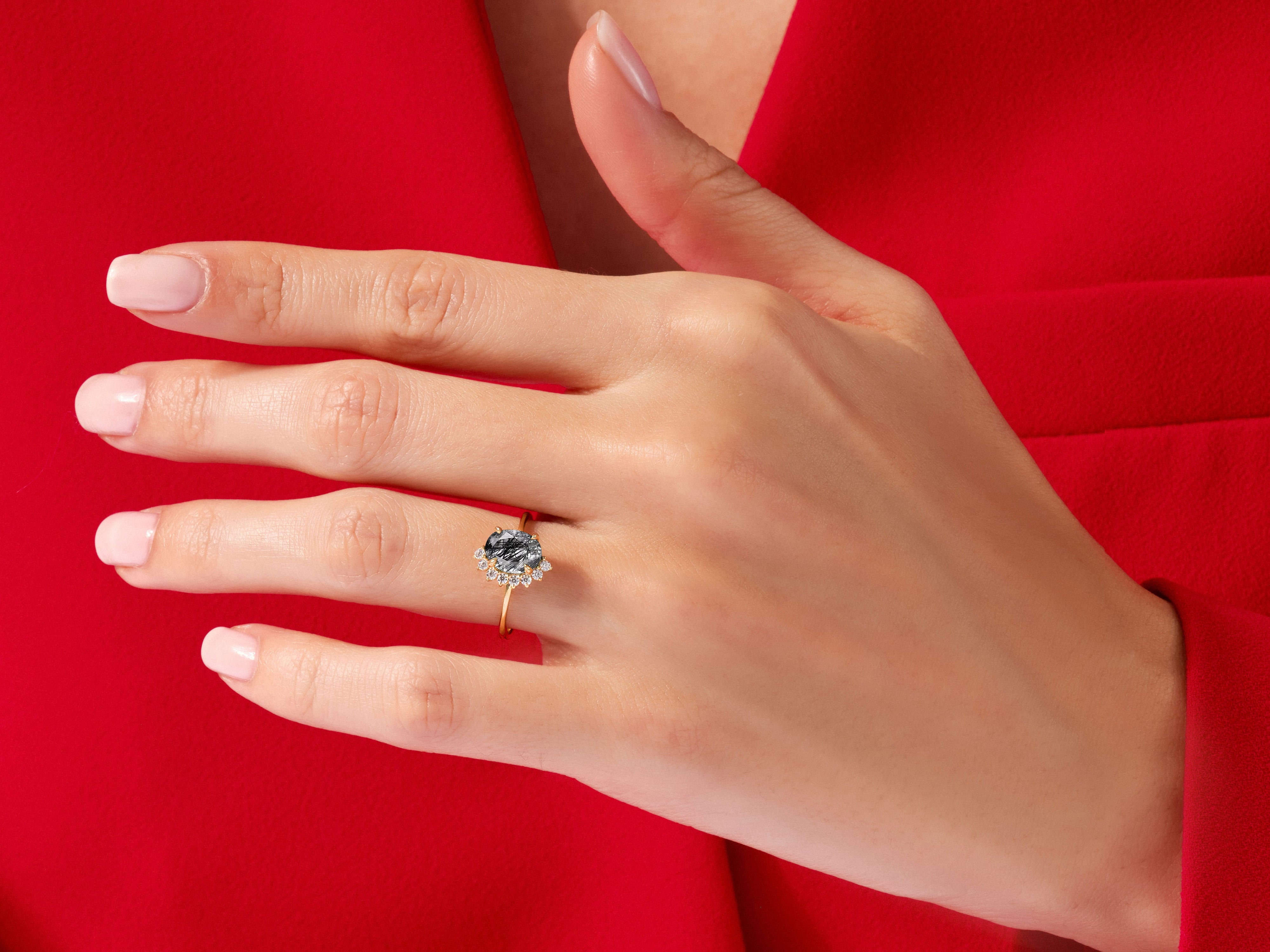Diamond engagement ring with black stone on hand