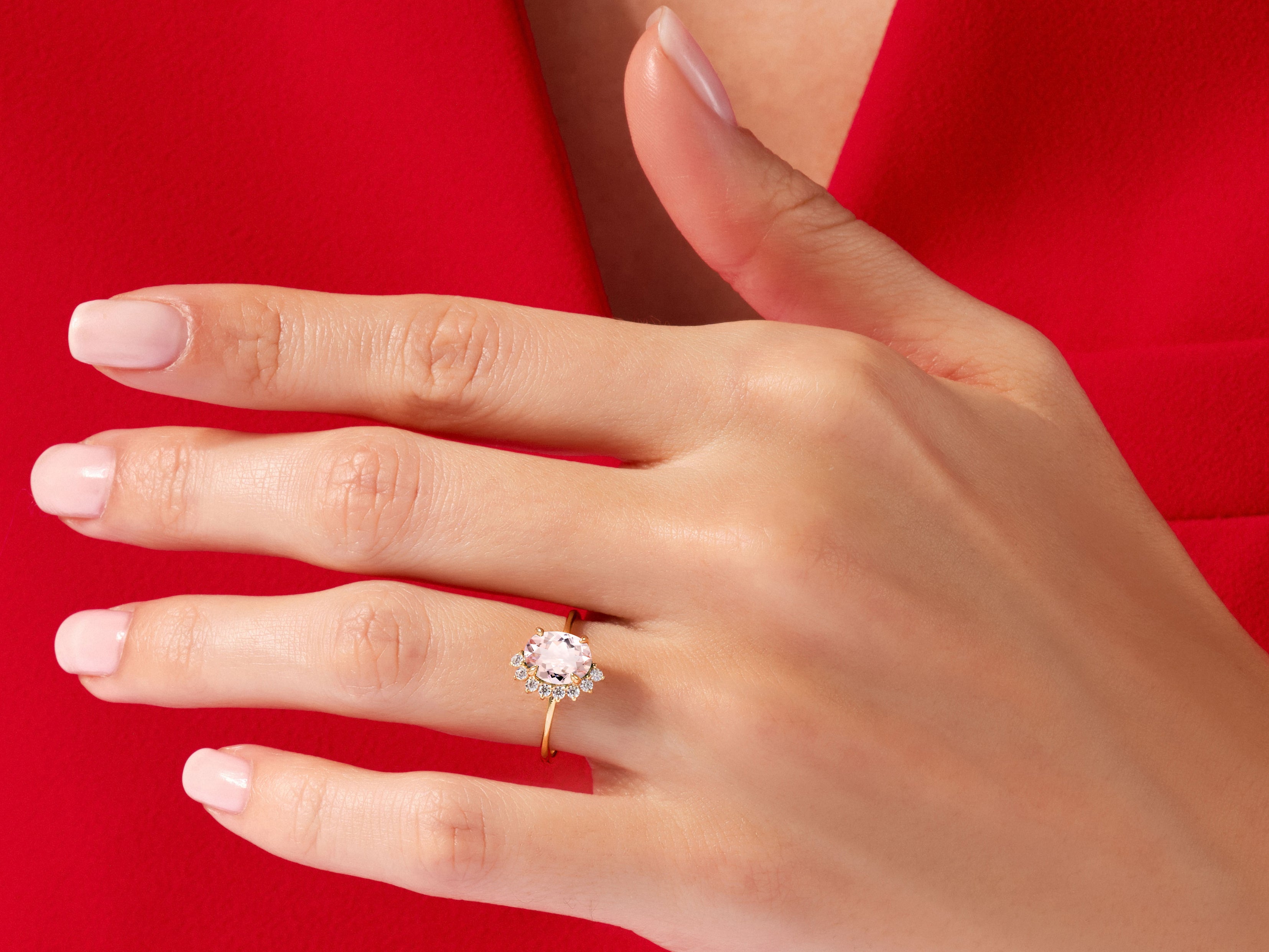 Gold ring with pink gemstone and diamonds on a hand
