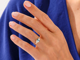 Gold ring with moss agate and diamonds on a woman's hand