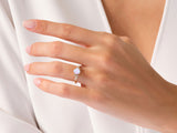 Gold opal ring with diamonds on a woman's hand
