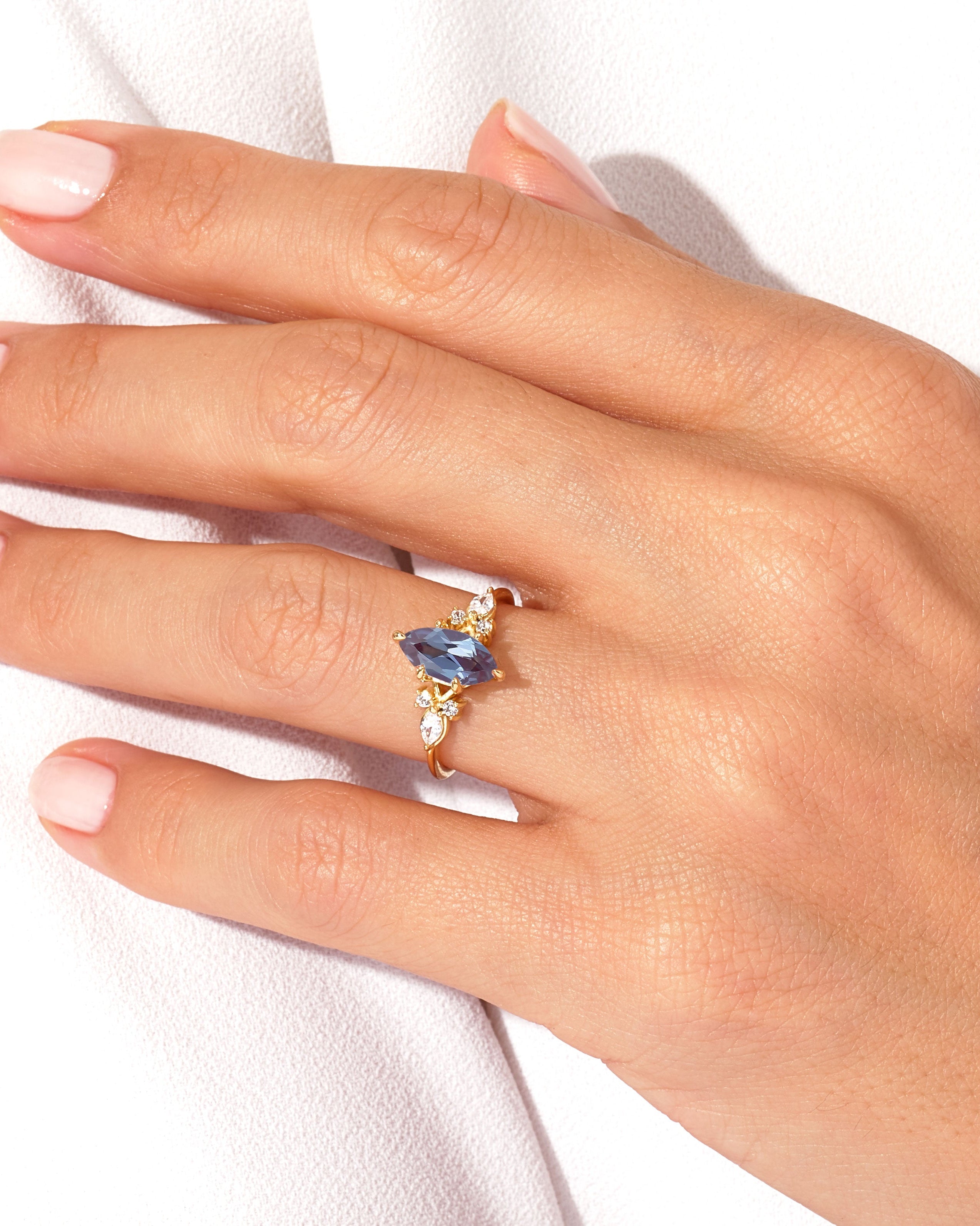 Marquise sapphire and diamond ring on a hand