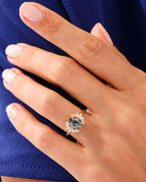 Gold ring with black rutile quartz and diamonds on a hand