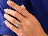 Gold ring with moss agate and diamonds on a hand