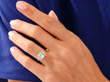 Gold ring with oval moonstone and diamond accents on hand