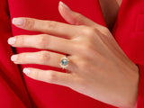 Gold ring with oval moss agate and diamond halo on hand
