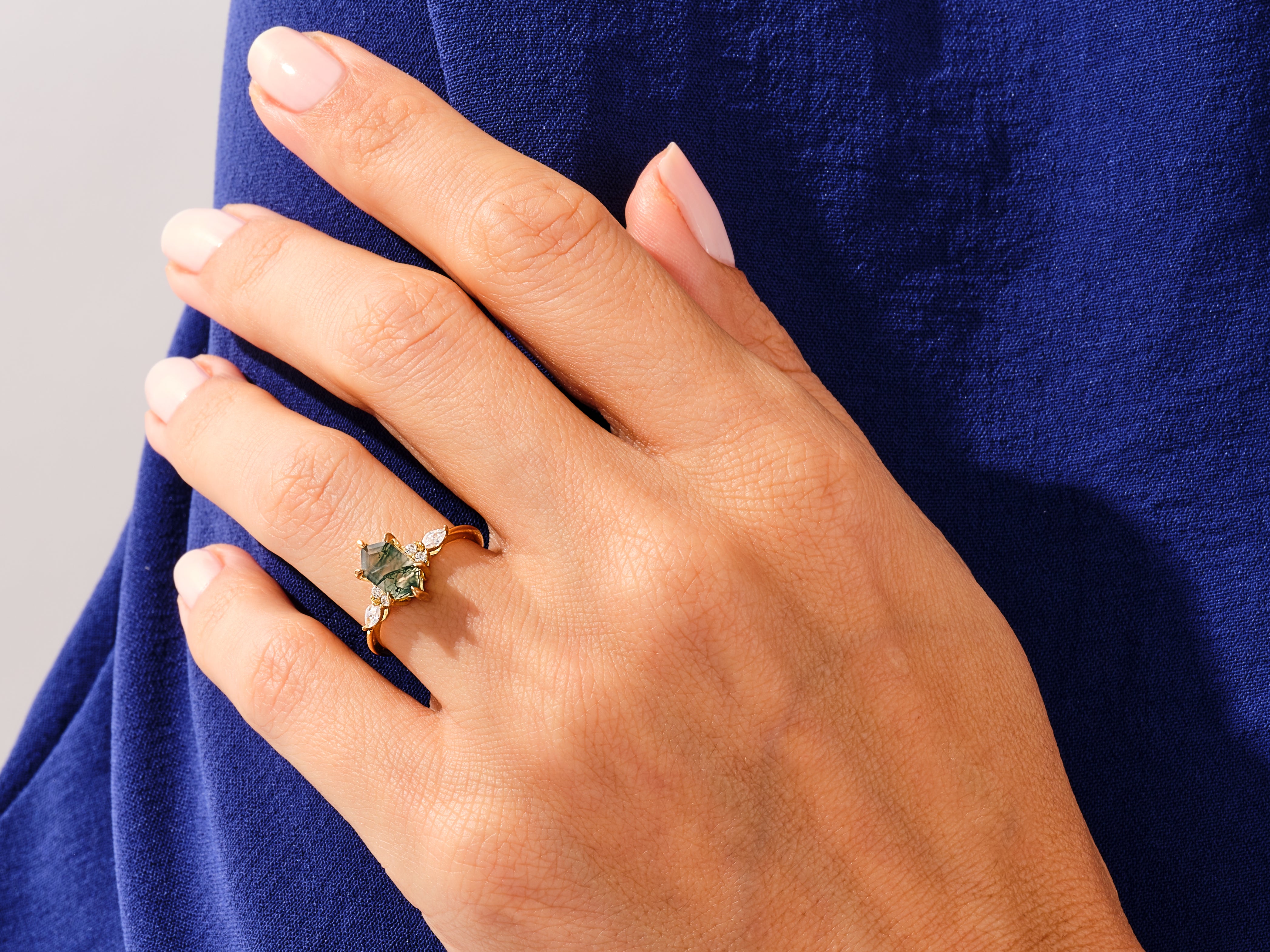 Gold ring with green moss agate and diamonds on hand