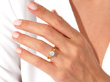 Gold ring with moonstone and diamonds on a woman's hand