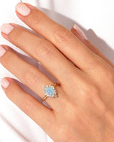 Gold opal diamond halo ring on hand