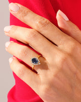 Gold pear-shaped sapphire ring with diamond halo