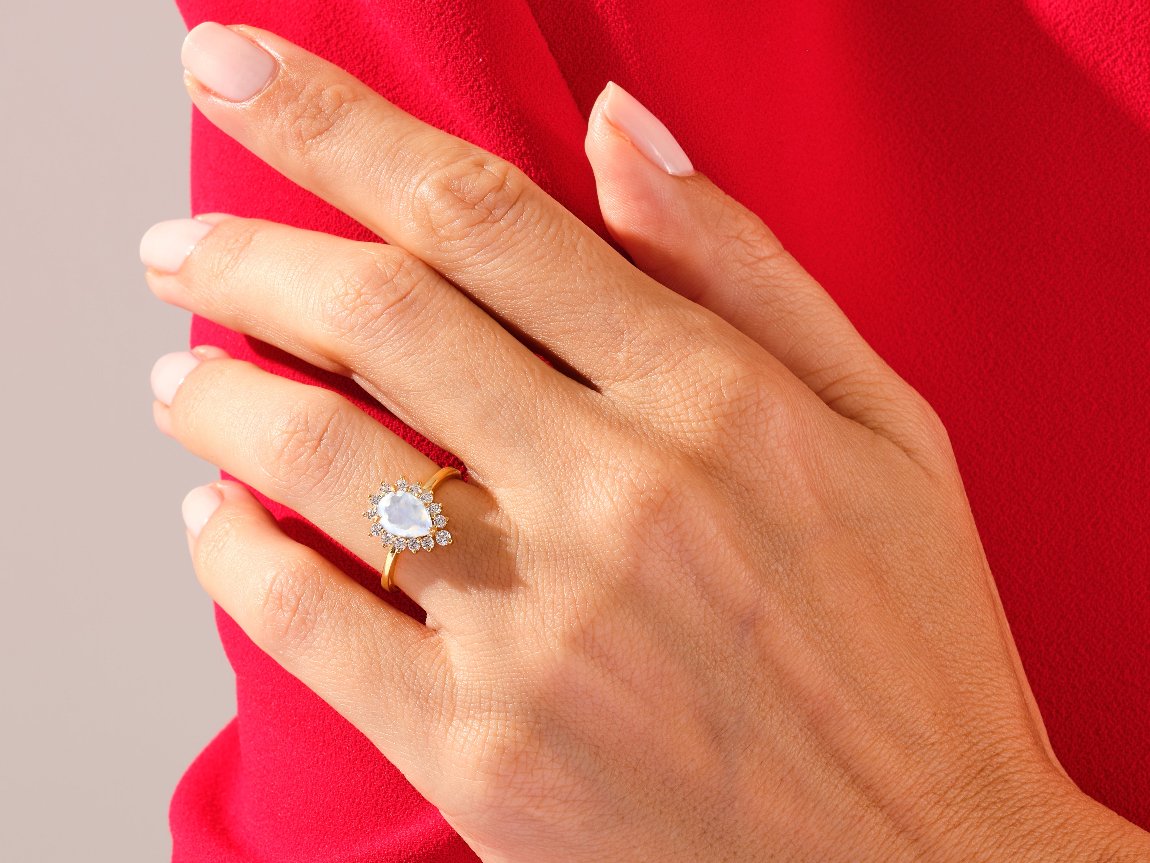 Gold ring with pear-shaped moonstone and diamond halo, jewelry