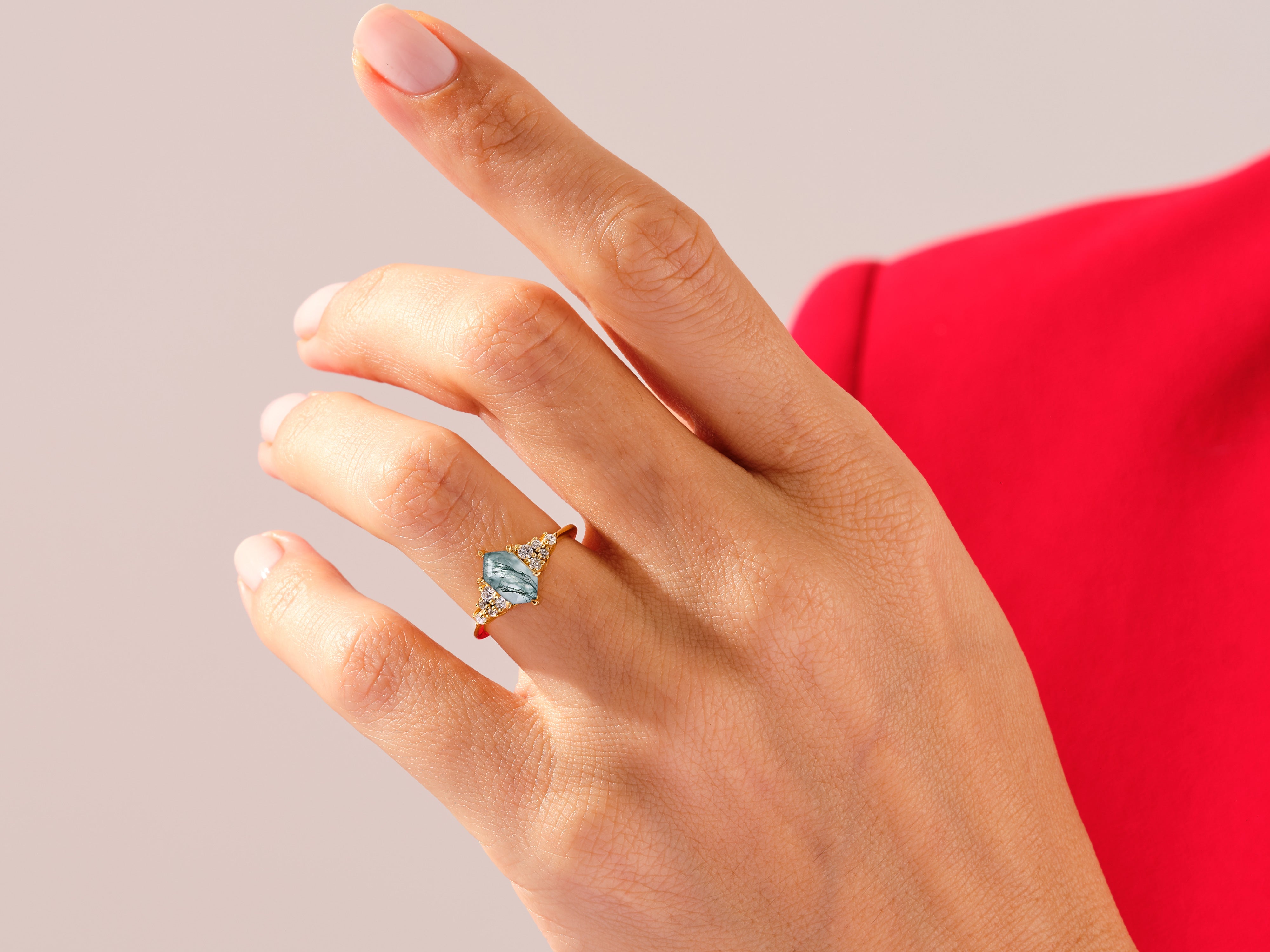Gold ring with blue gemstone and diamonds on a woman's hand