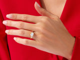 Gold ring with moonstone and diamonds on a hand