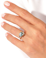Moss agate engagement ring with diamonds on a hand
