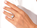 Gold opal ring with diamonds on a hand
