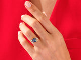Jewelry: Hexagonal gemstone ring with diamonds on a red background