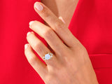 Opal and diamond engagement ring on a hand